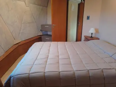 a bedroom with a large bed in a room at Domos in Santa Rosa de Calamuchita