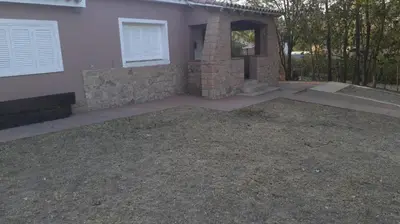 a house with a gravel yard in front of it at La Casa de la Esquina in Villa Icho Cruz