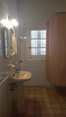 a bathroom with a sink and a window at La Casa de la Esquina in Villa Icho Cruz