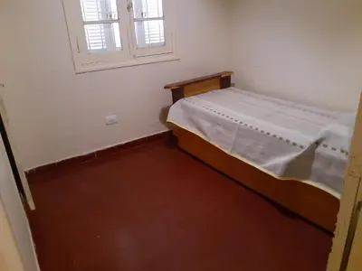 a small bedroom with a bed and a window at La Casa de la Esquina in Villa Icho Cruz