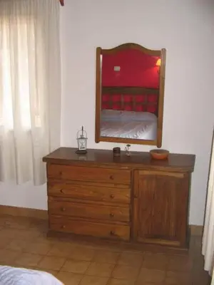 a bedroom with a dresser with a mirror on it at Casa Aurelia, San Javier, Córdoba in San Javier