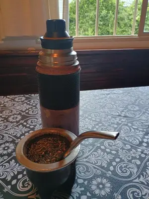 a cup of coffee sitting on a table with a spoon at Casa Aurelia, San Javier, Córdoba in San Javier