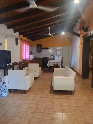 a living room with white couches and a table at Casa Aurelia, San Javier, Córdoba in San Javier