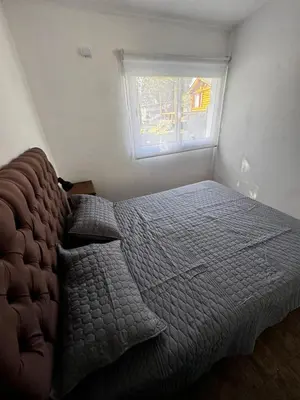 a bedroom with a bed and a window at Cabañas Estrellas del Lago in Potrero de Garay