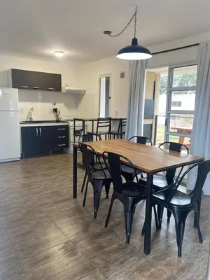 a kitchen and dining room with a table and chairs at Cabañas Estrellas del Lago in Potrero de Garay