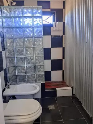 a bathroom with a toilet and a shower at La Casita de Villa Yacanto in Villa Yacanto