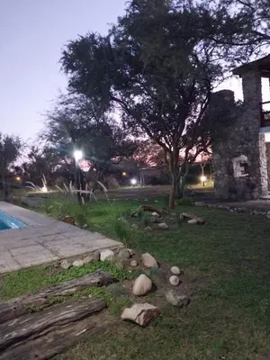 a yard with rocks and a tree and a building at soy ahora 1 y 2 in Pueblito