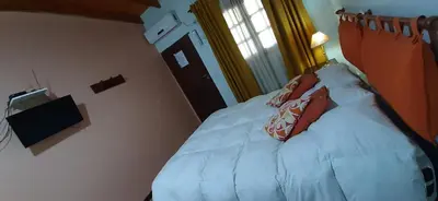 a bedroom with a bed with two pillows on it at La Arcadia in Mina Clavero