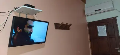 a flat screen tv hanging on a wall at La Arcadia in Mina Clavero