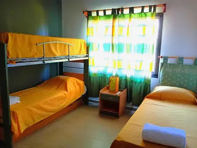 a bedroom with two bunk beds and a window at Brisas del Lago in La Estancia