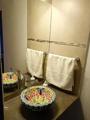 a bathroom with a sink and a toilet on a counter at Brisas del Lago in La Estancia