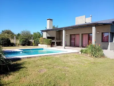 a house with a swimming pool in the yard at Brisas del Lago in La Estancia