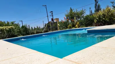 a swimming pool with blue water in a yard at Brisas del Lago in La Estancia