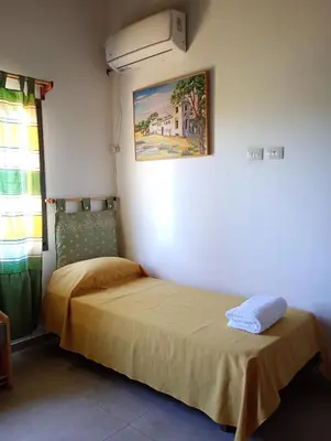 a bedroom with two beds and a air conditioner at Brisas del Lago in La Estancia
