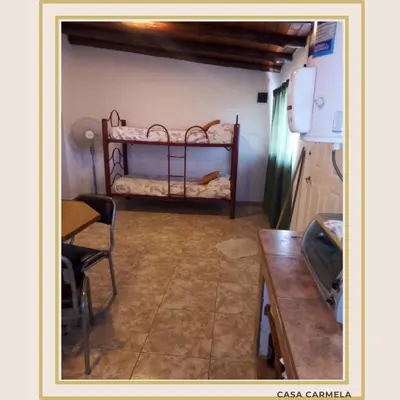 a room with a bed in the corner of a kitchen at CasaCarmela8 in Villa Carlos Paz