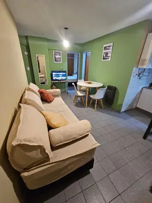 a bedroom with a bed and a table in a room at En la cañada cerca de todo in Cordoba