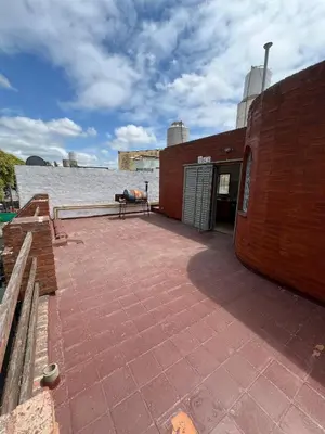 a patio with a bench on top of a brick building at Departamento Roxi in Cordoba