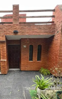 a brick building with a garage with a door at Departamento Roxi in Cordoba