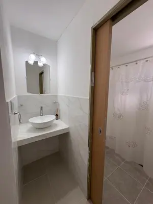 a bathroom with a sink and a shower at Departamento Roxi in Cordoba