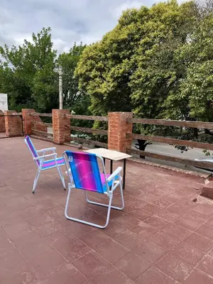 two chairs and a table on a patio at Departamento Roxi in Cordoba
