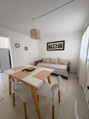 a living room with a table and a couch at Departamento Roxi in Cordoba