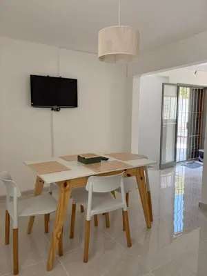 a dining room with a wooden table and chairs at Departamento Roxi in Cordoba