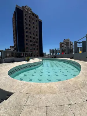 a large pool in the middle of a city at Departamento amoblado 1 dorm con amenities 516 INVERHOME INMOBILIARIA in Cordoba