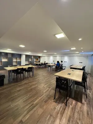 a large room with tables and chairs and people in the background at Departamento amoblado 1 dorm con amenities 516 INVERHOME INMOBILIARIA in Cordoba