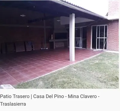 a patio of a house with a red tile floor at Del pino in Mina Clavero