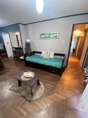 a bedroom with a green bed and a table at LitStay Paraná in Cordoba
