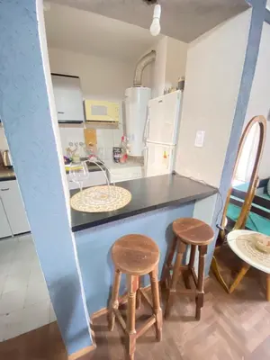 a kitchen with two chairs and a counter with a sink at LitStay Paraná in Cordoba