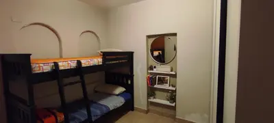 a bedroom with two bunk beds and a mirror at Complejo Bach in Villa Carlos Paz
