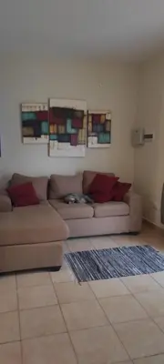 a living room with a brown couch in a room at Complejo Bach in Villa Carlos Paz