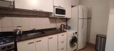 a kitchen with a sink and a refrigerator at Complejo Bach in Villa Carlos Paz