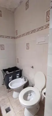 a bathroom with a toilet and a sink at Complejo Bach in Villa Carlos Paz