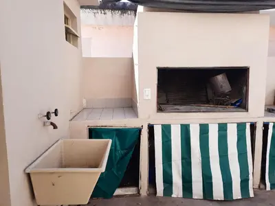 a bathroom with a sink and a fireplace at Las Camelias - chalet zona centro, aerosillas in Villa Carlos Paz