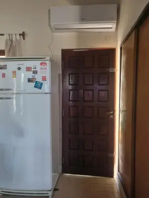 a refrigerator in a room with a door at Las Camelias - chalet zona centro, aerosillas in Villa Carlos Paz