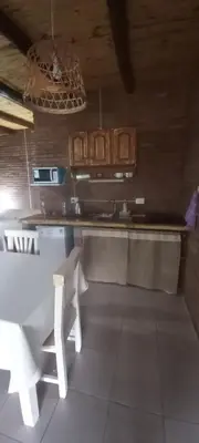 a kitchen with a table and a counter top at Ares cabaña de campo- Rincón de Afrodita in San Lorenzo