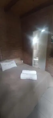 a bedroom with a large bed with towels on it at Ares cabaña de campo- Rincón de Afrodita in San Lorenzo