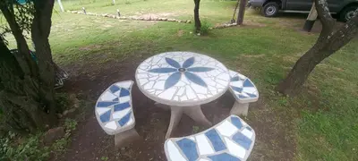 a blue and white table and benches in a park at Ares cabaña de campo- Rincón de Afrodita in San Lorenzo