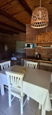 a kitchen with a table and chairs in a room at Ares cabaña de campo- Rincón de Afrodita in San Lorenzo