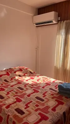 a bedroom with a bed with a quilt on it at departamento moreno151 in Villa Carlos Paz
