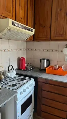 a kitchen with a stove and a counter top at departamento moreno151 in Villa Carlos Paz