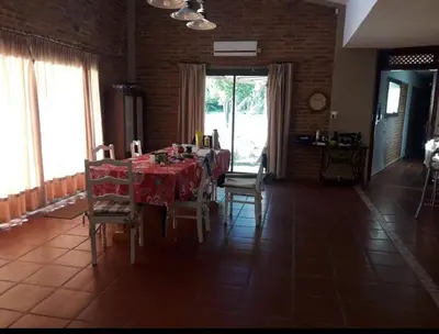 a dining room with a table and chairs in a room at Casa de verano confortable in Villa de Las Rosas