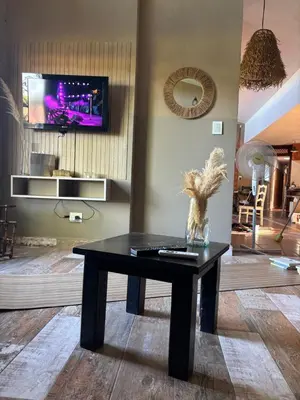a black coffee table in a living room with a tv at Casa de verano confortable in Villa de Las Rosas