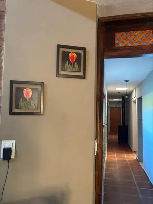 a hallway with two framed pictures on the wall at Casa de verano confortable in Villa de Las Rosas