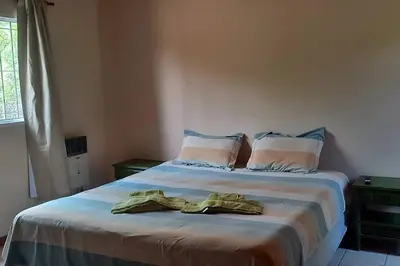 a bedroom with a bed with two towels on it at Casa Despertares - Las Rabonas in Mina Clavero