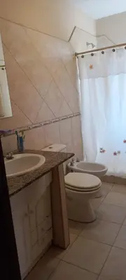 a bathroom with a toilet and a sink and a shower at Casa Despertares - Las Rabonas in Mina Clavero