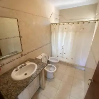 a bathroom with a sink and a toilet at Casa Despertares - Las Rabonas in Mina Clavero