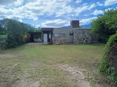 a house with a stone building with a yard at Casa Despertares - Las Rabonas in Mina Clavero